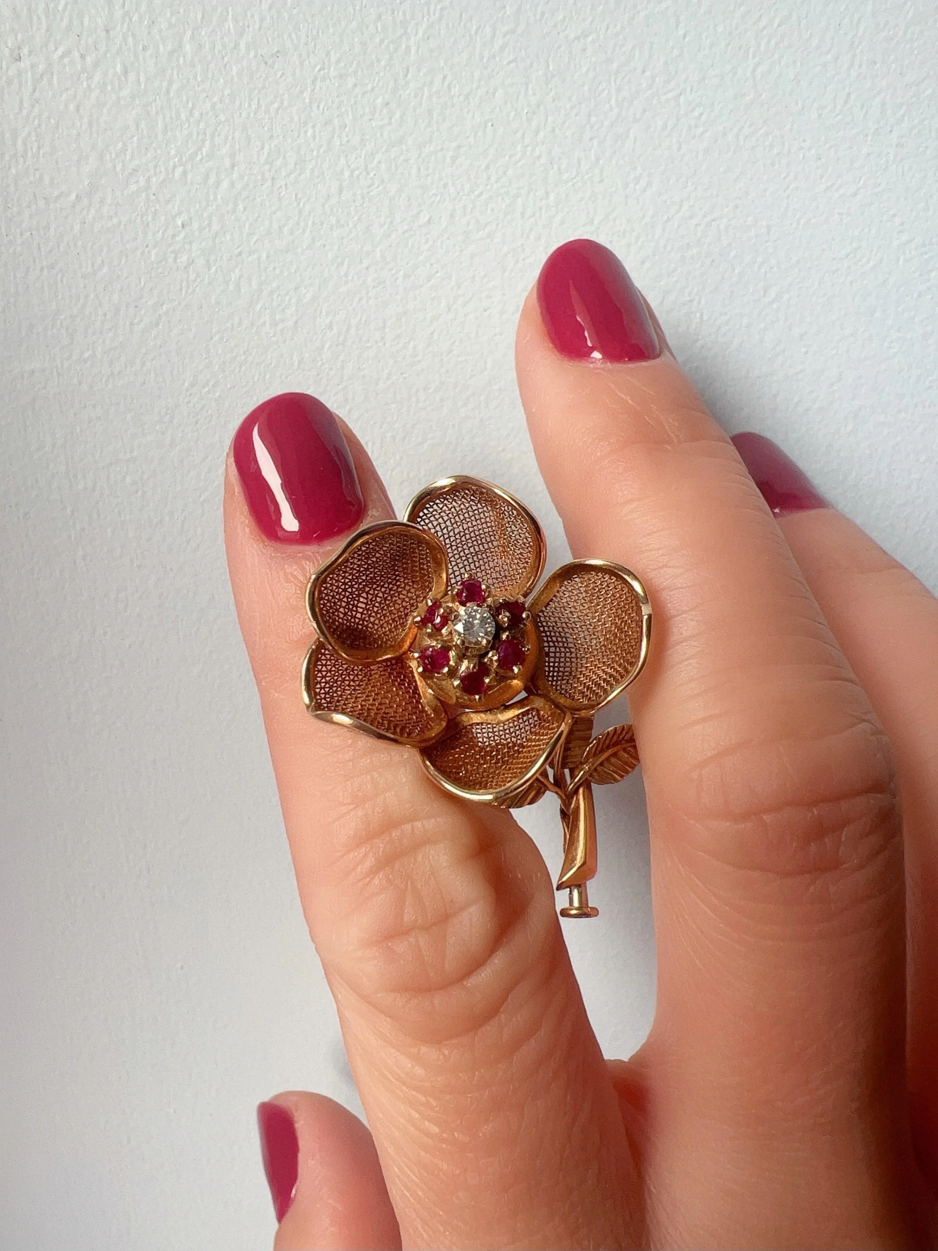 Vintage 18K gold opening rose brooch with articulated petals